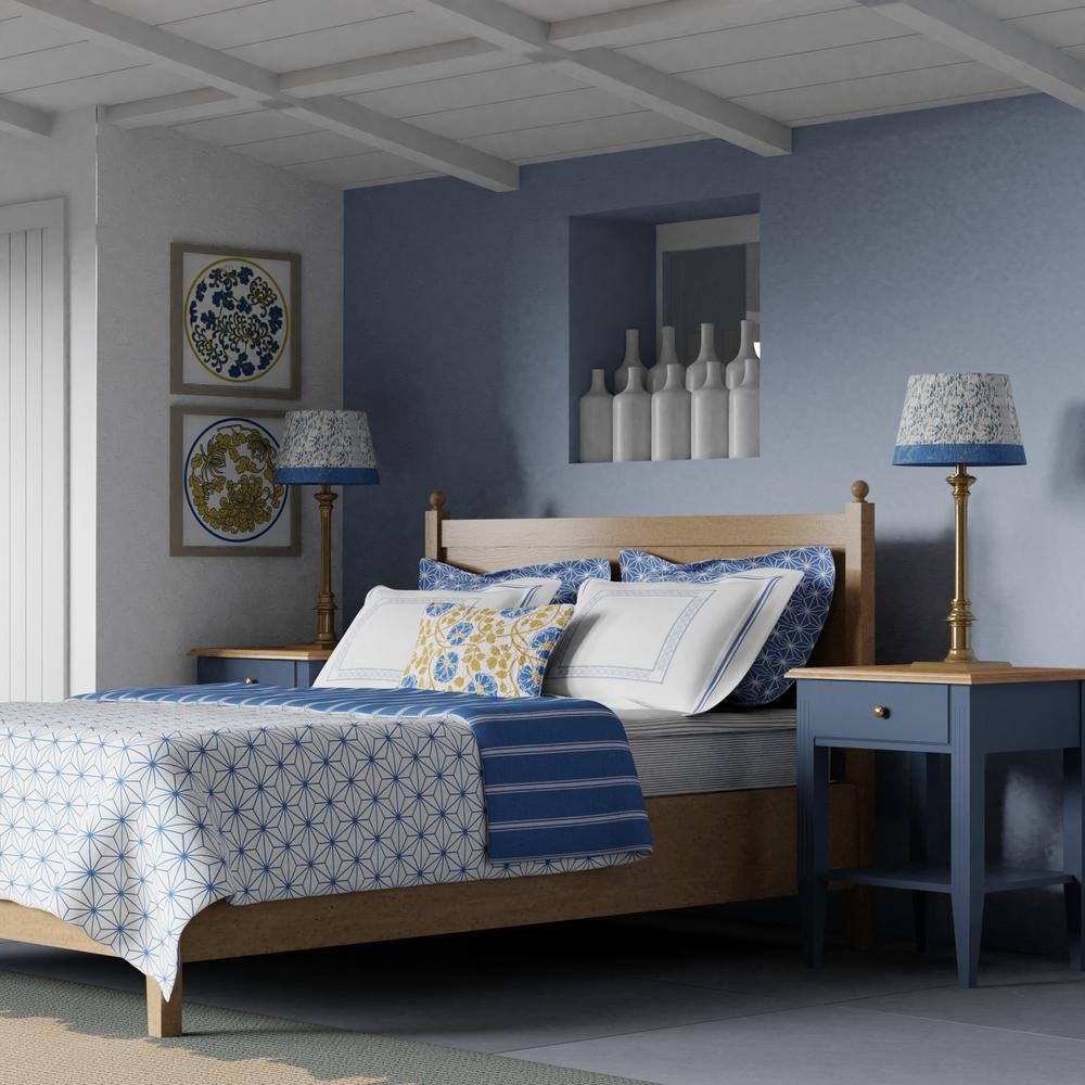 Marbella wood bed in a blue and gold bedroom